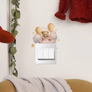 Detailed view of a cute brown bear wall sticker with yellow balloons above a light switch