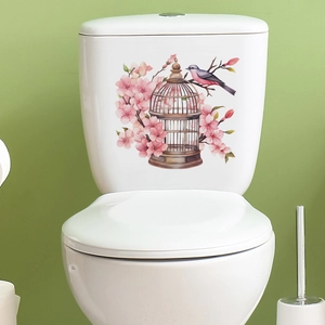 Floral birdcage toilet sticker with pink cherry blossoms and a bird on a white tank
