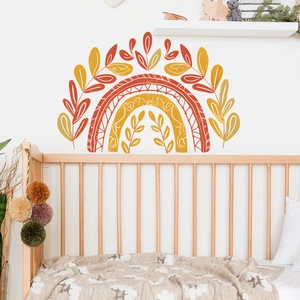 Detail view of Bohemian rainbow wall stickers with leaf patterns in a cozy nursery room