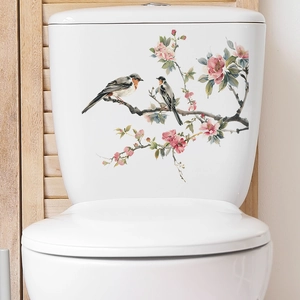 Floral wall sticker with birds and plum blossoms on a white ceramic toilet tank