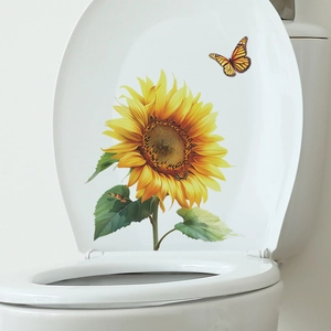 Detail of sunflower and butterfly decal applied on a white toilet lid for bathroom decor