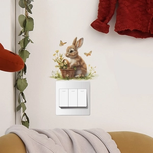 Detail of cute rabbit and flower basket wall sticker above white light switch
