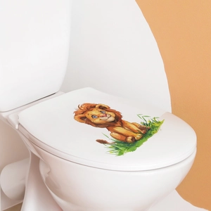 Detailed view of a cute cartoon lion wall sticker applied to a white toilet lid in a bathroom