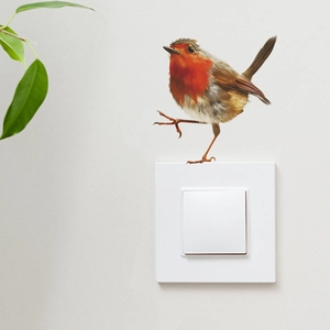 Realistic robin bird wall sticker placed on white light switch with green leaf detail