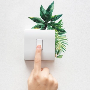 Tropical green plant leaf wall stickers for home decor on a square light switch