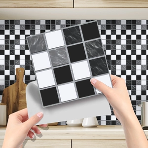 Detail showing self-adhesive backing of black and white marble pattern mosaic tile sticker