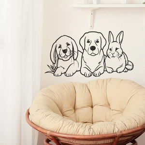 Detail of minimalist hand-drawn dog and rabbit wall stickers in a cozy bedroom setting