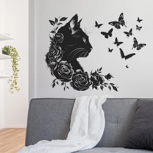 Decorative wall sticker with black cat silhouette, roses and butterflies over a sofa