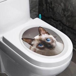 Detail showing 3D visual effect of a blue-eyed Siamese cat sticker on a toilet lid