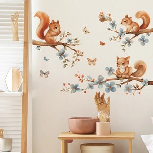 Detailed view of cartoon squirrels and floral wall stickers in a warm home setting