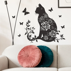 Detail of black cat silhouette wall sticker with rose patterns and butterfly accents