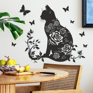 Black cat wall decal with rose patterns and butterflies on a white living room wall