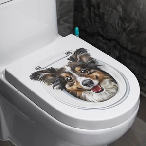Detail of creative 3D puppy dog sticker applied on a white bathroom toilet lid