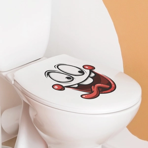 Sticker WC rigolo avec visage cartoon, grands yeux et langue sur abattant blanc