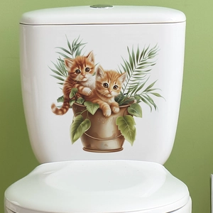 Detail of waterproof toilet sticker featuring orange kittens in a bucket with green leaves