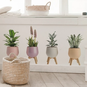 Close-up of 3D potted plant wall stickers featuring green leaves and wooden tripod stands