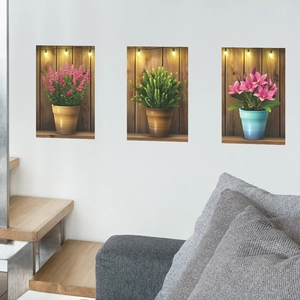 Three-piece botanical wall art set with potted plants and fairy lights on wood background