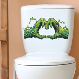 Funny Halloween green zombie hands heart-shaped sticker on a white ceramic toilet tank