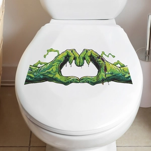 Halloween toilet lid sticker featuring green zombie hands forming a heart shape on a white lid