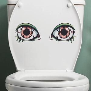 Close-up of Halloween monster eye toilet stickers with green drip effects and red veins