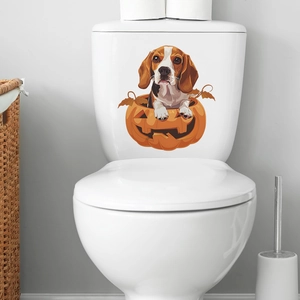 Close-up of a cartoon beagle dog in a pumpkin sticker applied to a white toilet tank