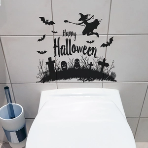 Macro detail of black PVC Halloween toilet sticker with witch bat and graveyard silhouette