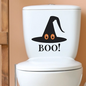 Macro detail of Halloween witch hat sticker with Boo text on white toilet tank