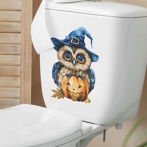 Close-up of a watercolor owl with wizard hat and pumpkin decal on white toilet tank
