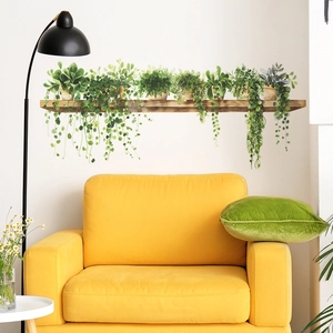 Potted green plants wall decal above a yellow armchair in a modern living room