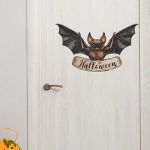Detailed view of a cartoon bat wall sticker with Halloween banner on a white wooden door