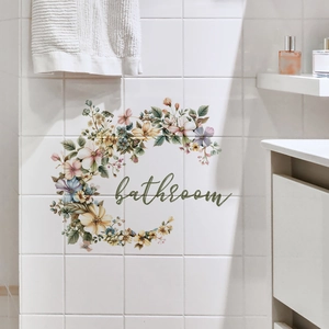 Close-up of bathroom wall decal with colorful floral wreath on white grid tile wall