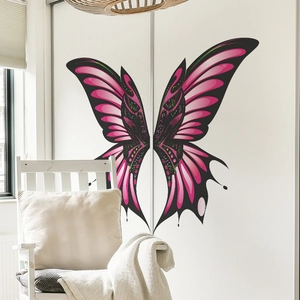 Vibrant pink butterfly wing wall stickers on a minimalist white wardrobe in a bedroom