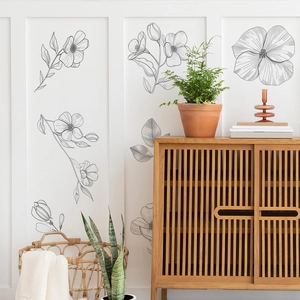 Detail of black and white sketch floral wall stickers on a white wall in a living room