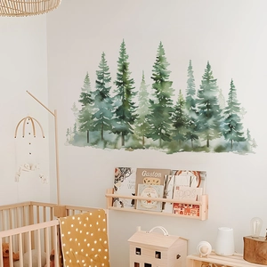 Detailed watercolor pine tree forest wall decal shown above a wooden baby crib