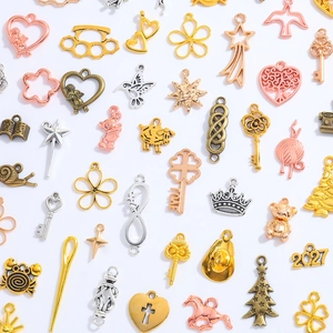 Mix of 100 assorted vintage alloy charms in gold, silver, and bronze for DIY jewelry making