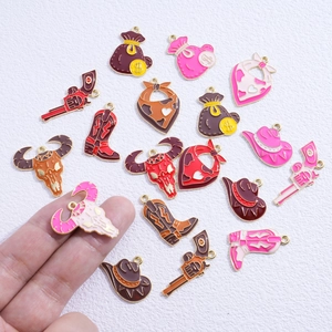 Assorted enamel Western cowboy charms including boots, hats, and skulls for DIY jewelry