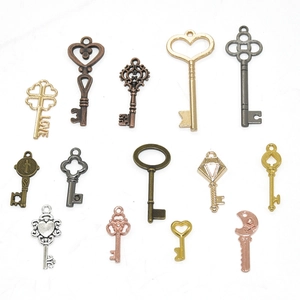 Assorted vintage metal key charms in gold and bronze for DIY jewelry making and crafts
