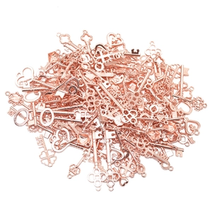 Detailed macro view of rose gold vintage alloy key charms with intricate love heart patterns