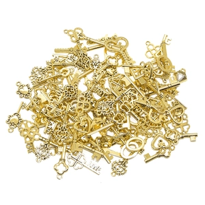 Macro shot of assorted golden vintage alloy key charms with heart and cross patterns