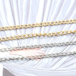 Detailed macro view of 4mm gold and silver plated iron cable chains for DIY jewelry making