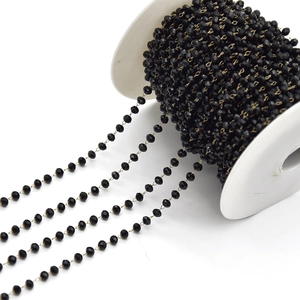 Detail of faceted black crystal beads on gold chain for DIY jewelry making