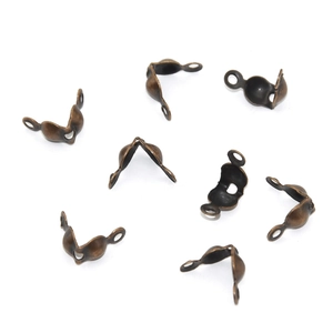 Macro shot of antique bronze jewelry crimp bead covers for DIY necklaces and bracelets