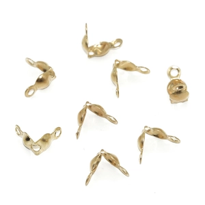 Macro detail of golden clamshell bead tips for DIY handmade jewelry necklace making