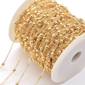 Polished 4mm gold beaded ball chain on a white spool for DIY jewelry making and crafts