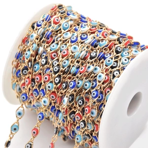 Colorful evil eye beads on gold plated chain for DIY jewelry making on white spool