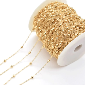 Golden 4mm satellite bead chain on a white spool for DIY jewelry making accessories