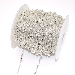 Close-up of silver-plated 4mm beaded chain roll for DIY jewelry and tassel making