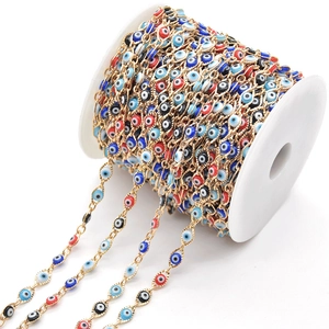 Detail of colorful evil eye beads on a golden copper chain for DIY jewelry making