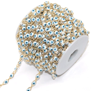 Detail of evil eye chain roll with blue enamel beads and gold-plated copper links