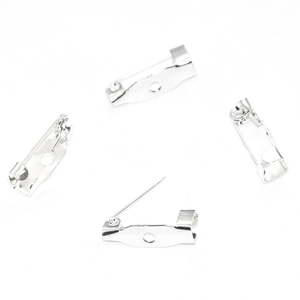 Macro detail of silver safety pin base for DIY jewelry brooches in sets of four